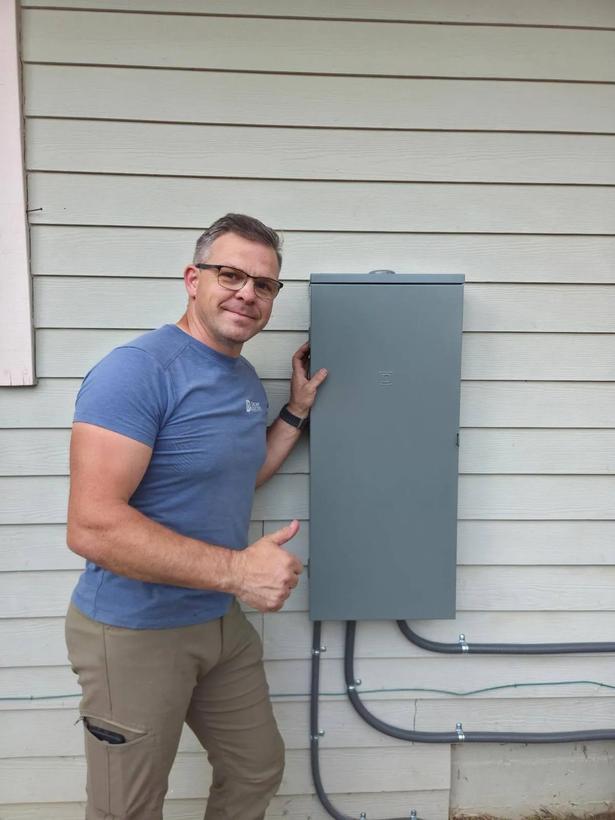 Daniel Dican beside a completed exterior panel replacement